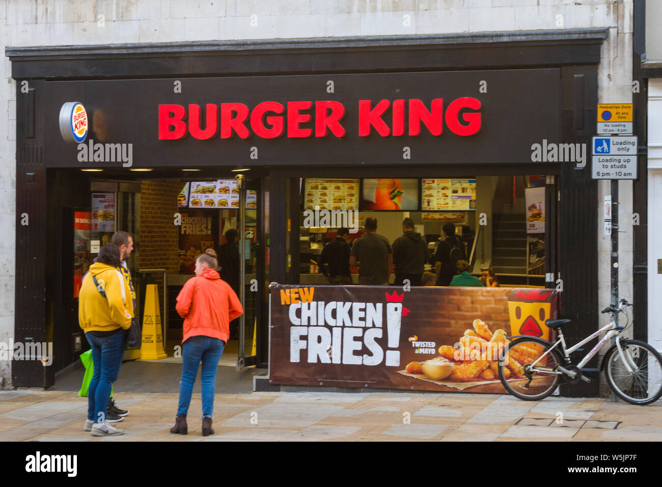 A group of people outside a branch of Burger King in Cornmarket Street, Oxford. Stock Photo