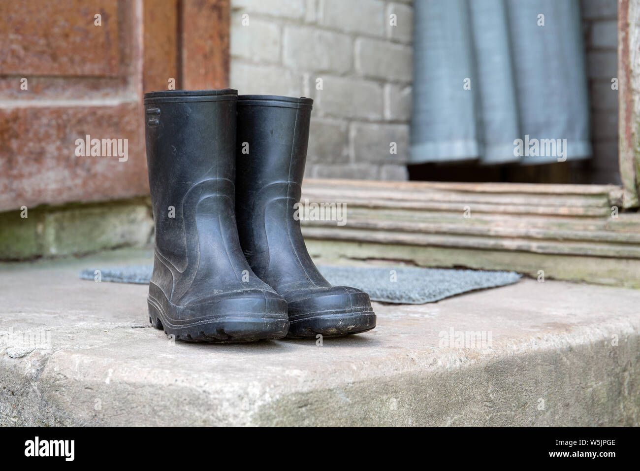 Rubber boots on concrete stairs Stock Photo - Alamy