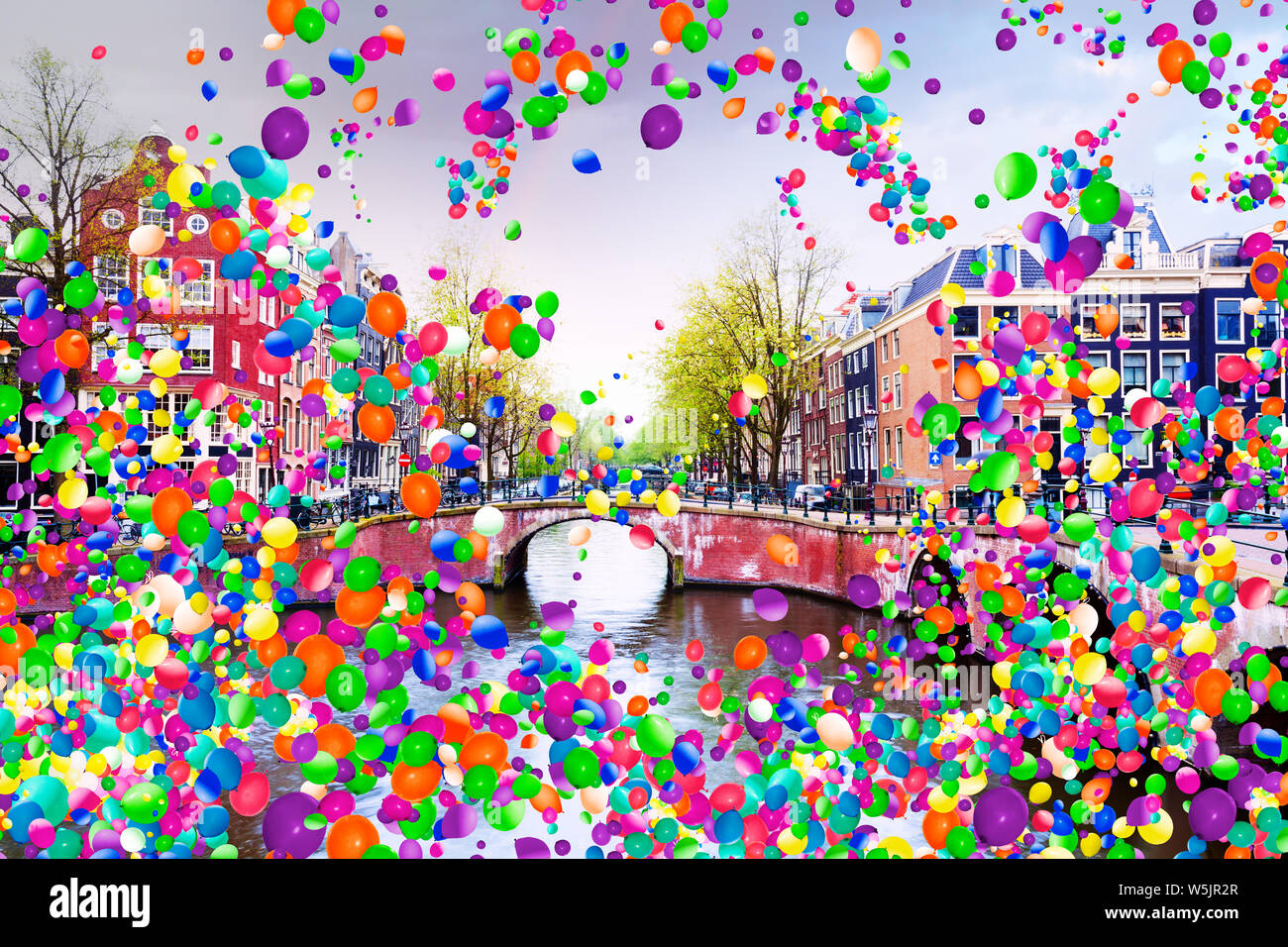 Amsterdam canal Netherlands and many colorful air balloons flying