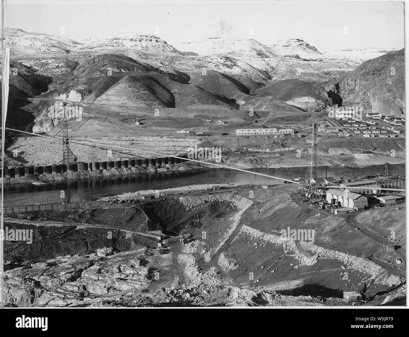 A three-view panorama of the development from top of east abutment.; Scope and content:  Photograph from Volume Two of a series of photo albums documenting the construction of the Grand Coulee Dam and related work on the Columbia Basin Project. General notes:  This image is part of a panoramic view which includes items 933, 934, and 935. The original image measures approximately 27 inches in width. Stock Photo