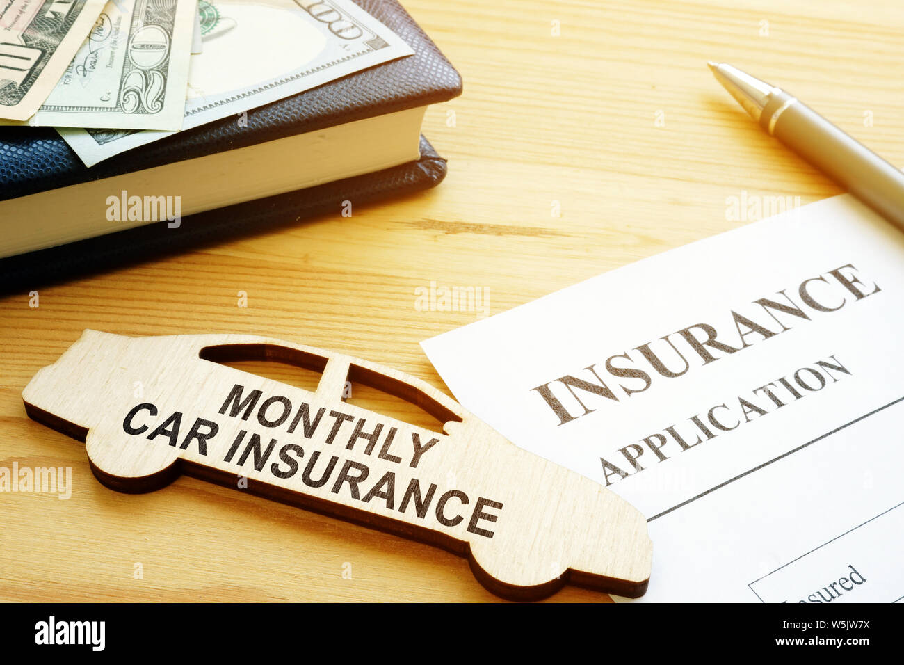 Monthly car insurance application form and money. Stock Photo