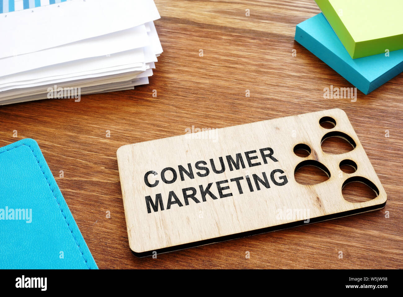 Consumer marketing sign on a plate and business report. Stock Photo