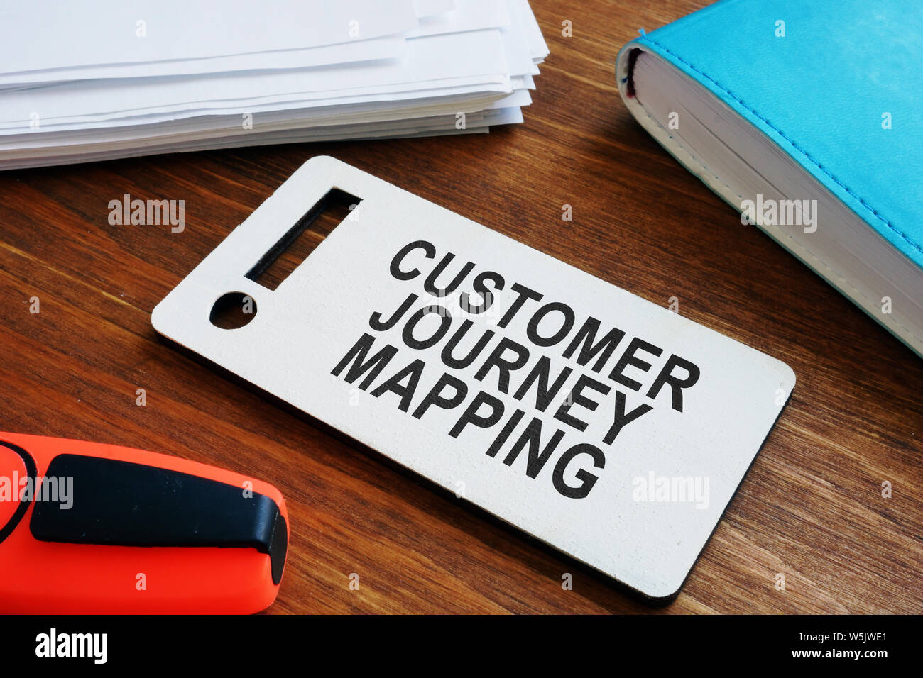 Plate with sign Customer journey mapping and papers with map. Stock Photo
