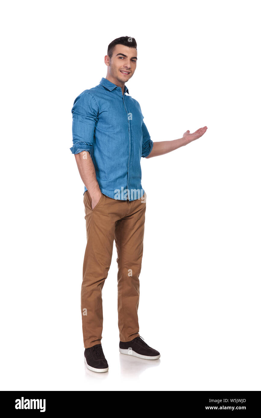 relaxed casual man standing on white background and presenting to side,  full body picture Stock Photo - Alamy