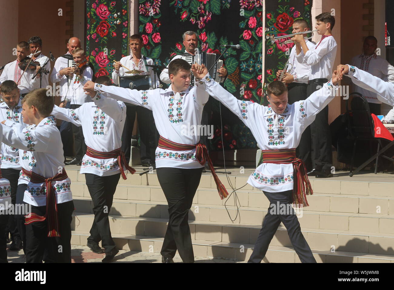Performing folk dances in the Moldavian national costumes at the folklore festival in the village of Cotala, Moldova. Stock Photo