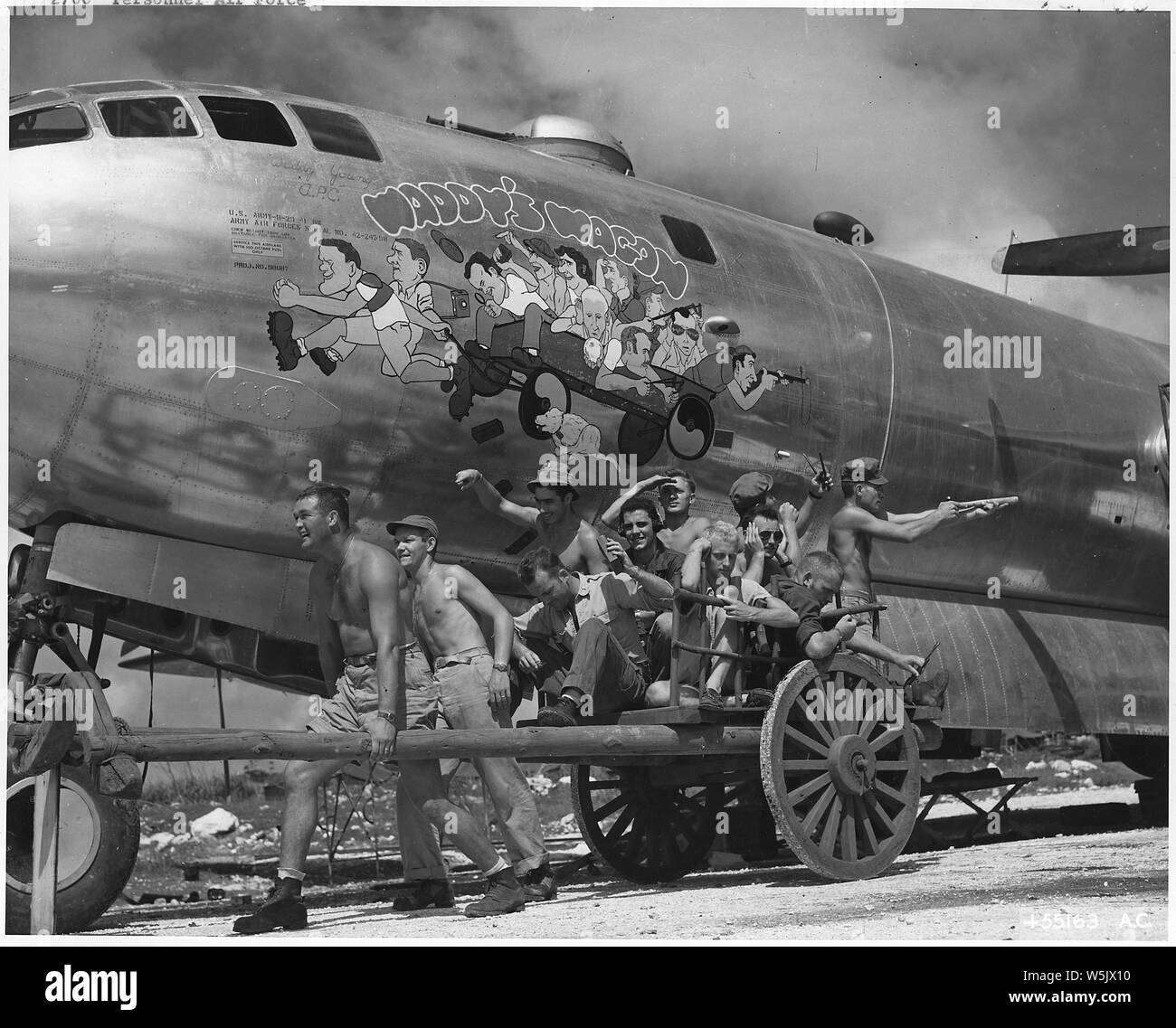 Air Force personnel & equipment. The Pacific, England, Wash. DC. 1942-44 (mostly 1943); Scope and content:  B-29 Men bombed Tokyo. The crew of Waddy's Wagon, fifth B-29 to take off on the initial Tokyo mission from Saipan, and first to land after bombing the target. Crew members, posing here to duplicate their caricatures on the plane, are : Plane C. O., Capt. Walter R. Waddy Young, Ponca City, Okla., former All-American end; Lt. Jack H. Vetters, Corpus Christi, Texas, pilot; Lt. John F. Ellis, Moberly, Mo., bombardier; Lt. Paul R. Garrison, Lancaster, Pa., navigator; Sgt. George E. Avon, Syra Stock Photo