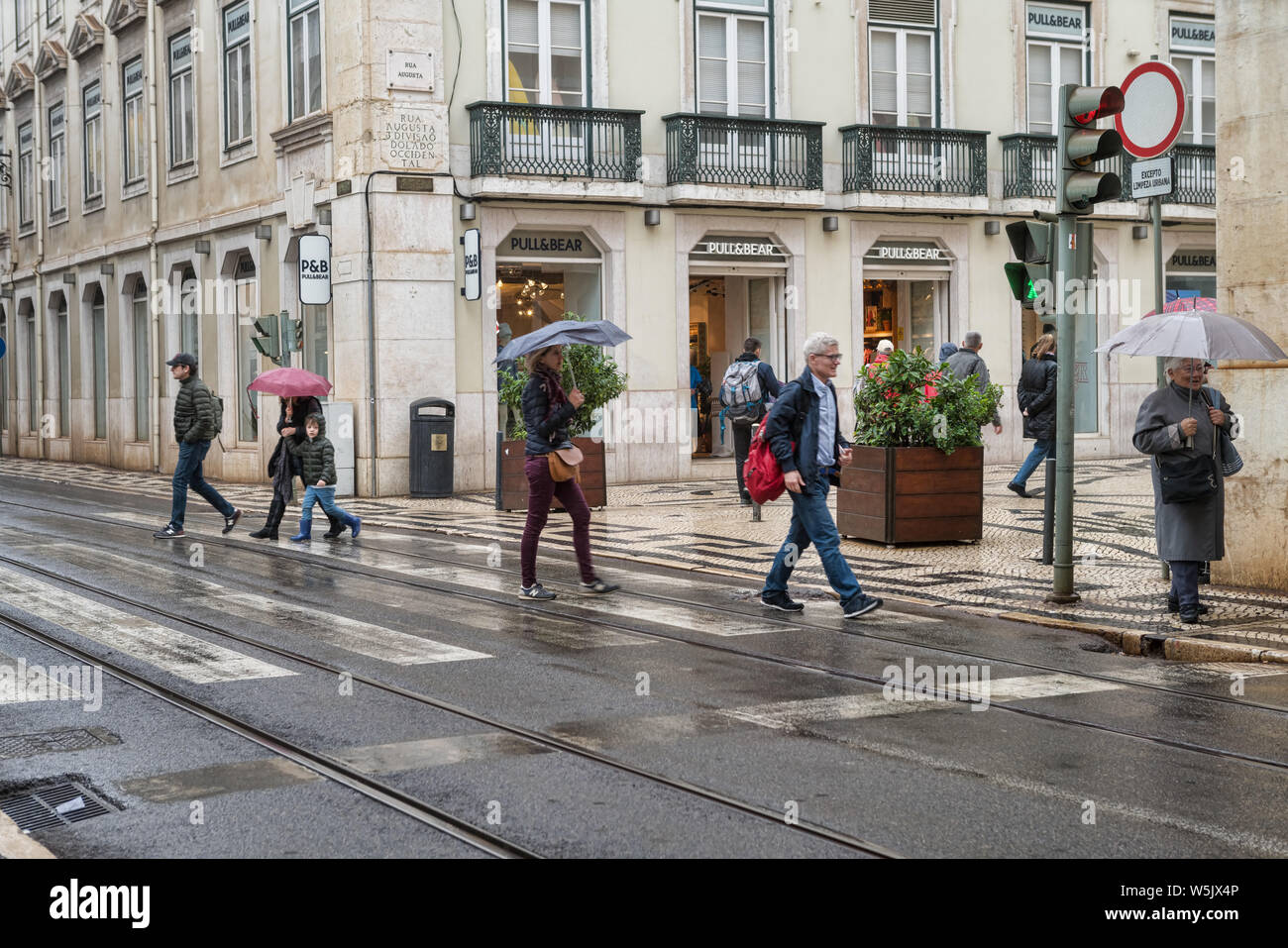 People walking around in shopping district in Lisbon, Portugal. Famous city center tourist travel attraction, many shopping centers and stores Stock Photo