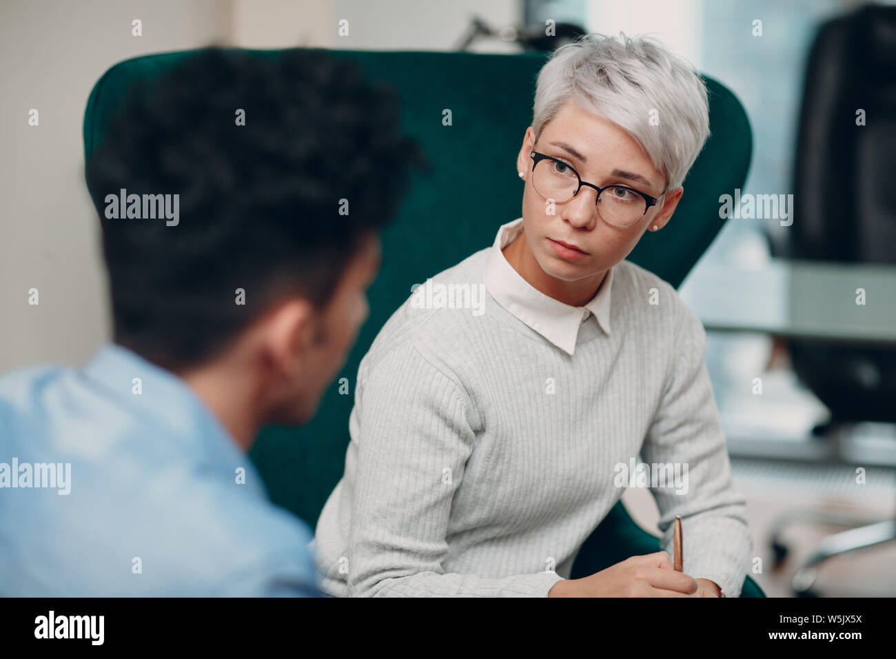 Consultation of young male patient on reception for psychologist. Family problems Stock Photo