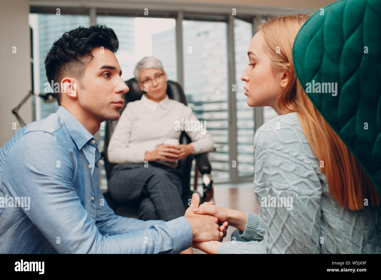 Consultation of couple young man and woman patient on reception for psychologist. Family problems Stock Photo