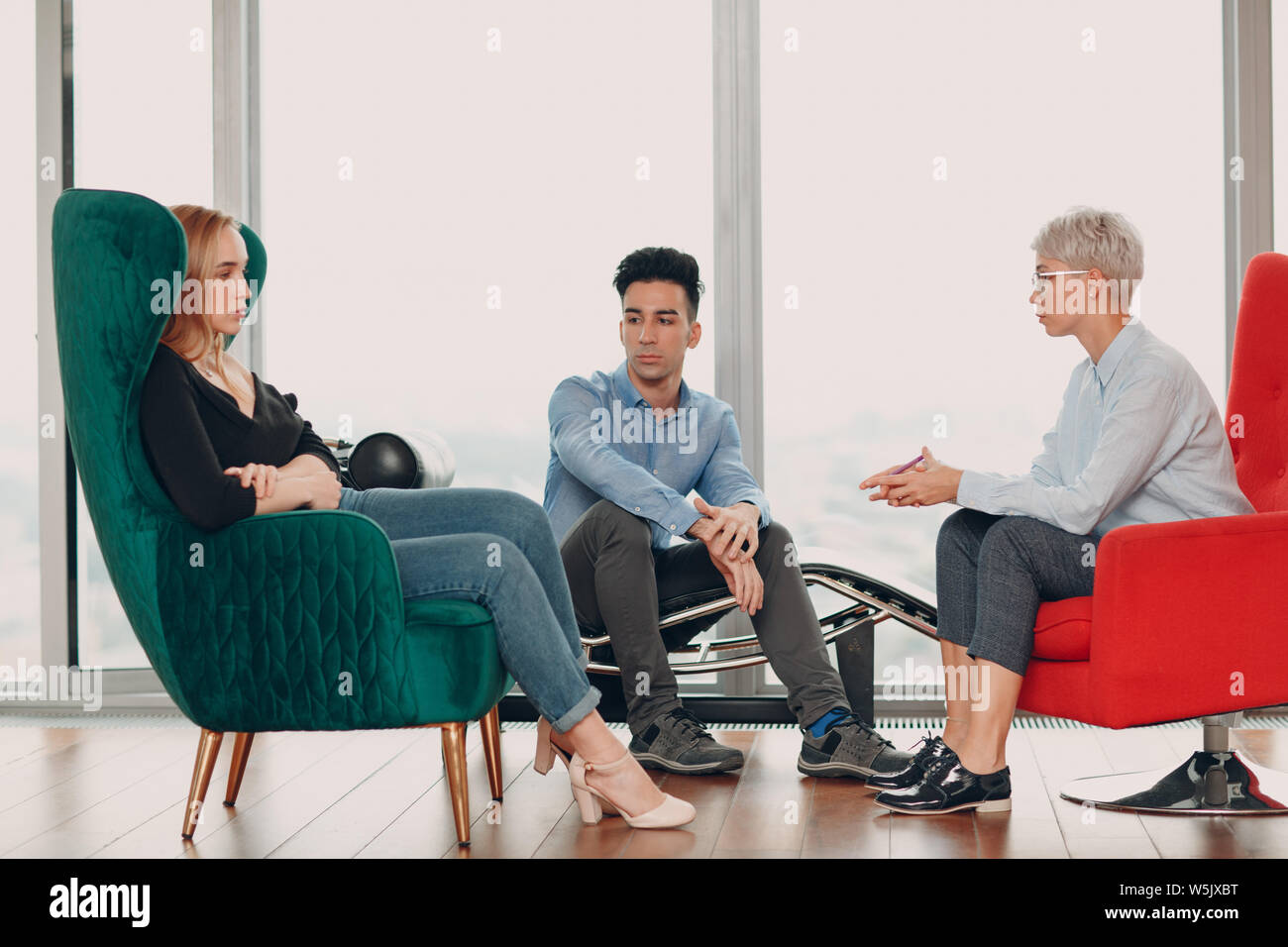 Consultation of couple young man and woman patient on reception for psychologist. Family problems concept. Stock Photo