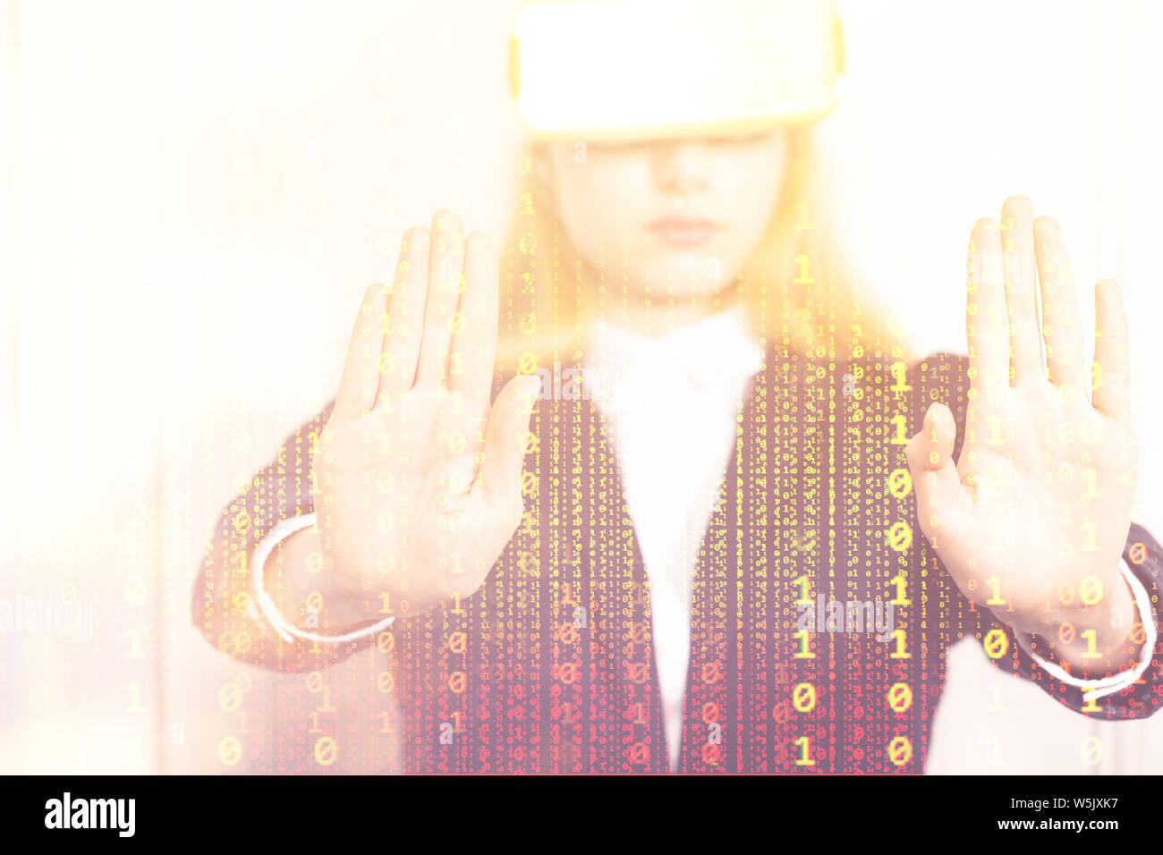 Young tech woman in Virtual reality headset device manipulate digital binary code numbers with hands Stock Photo
