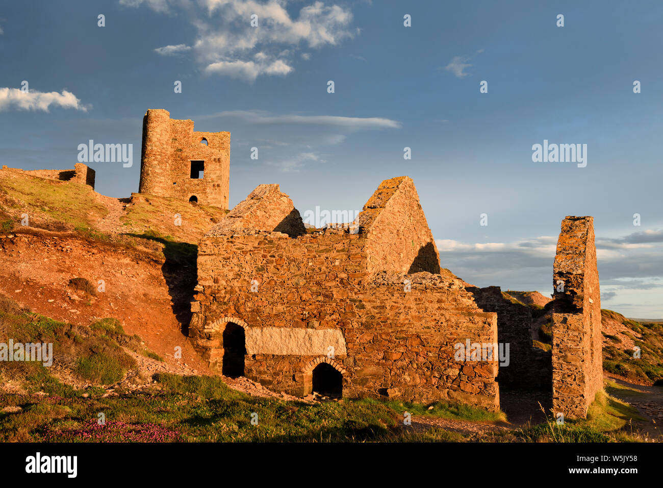 Ruins of Wheal Coates tin mine in Cornwall England with red light at sunset with Stamps and Whim Engine house and Double-Bayed Calciner Stock Photo