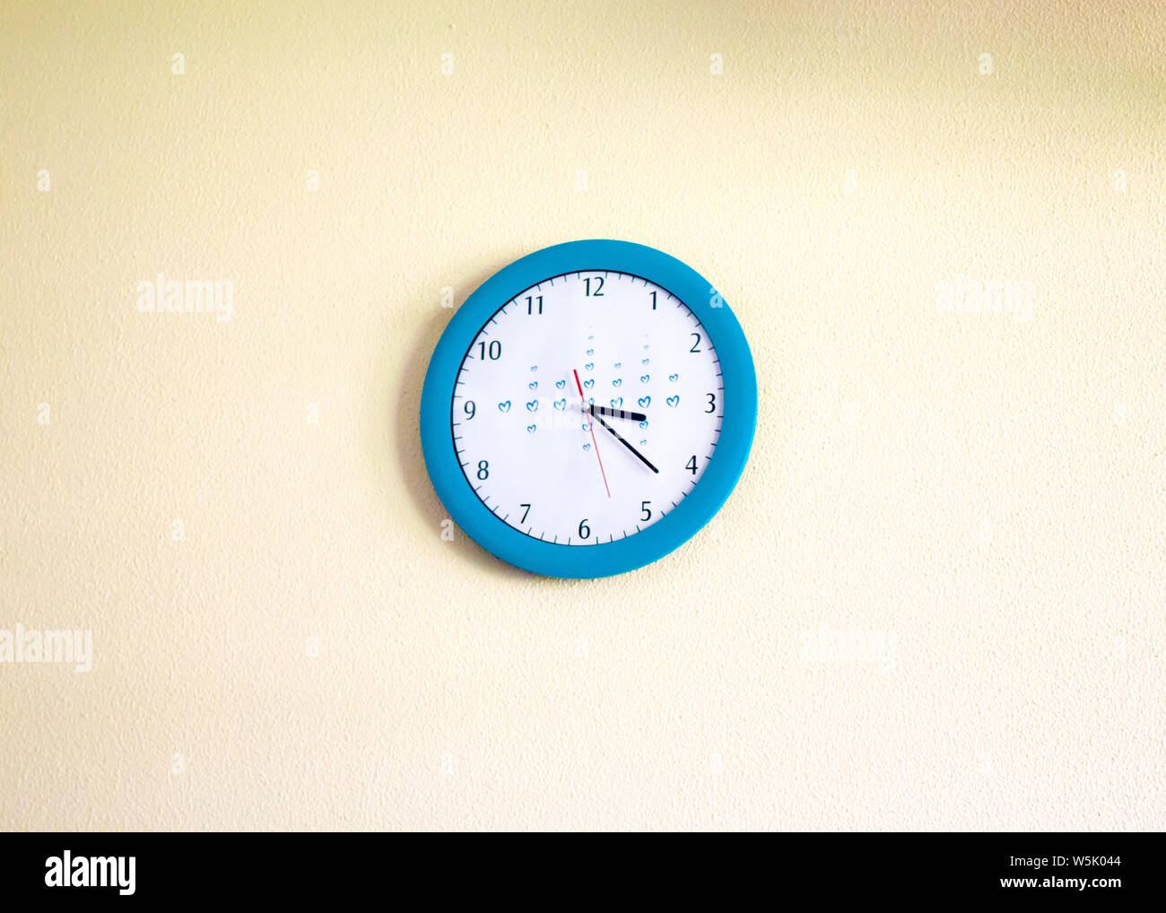Clock hanging on the wall Stock Photo Alamy