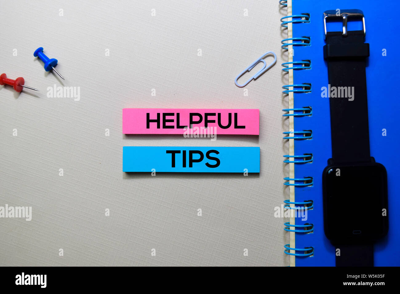 Helpful Tips text on sticky notes isolated on office desk Stock Photo