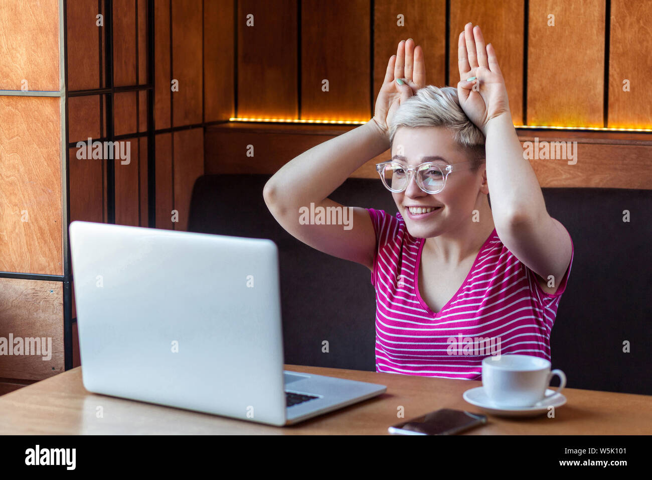 Happy Childish Young Girl With Blonde Short Hair In Pink Shirt Is