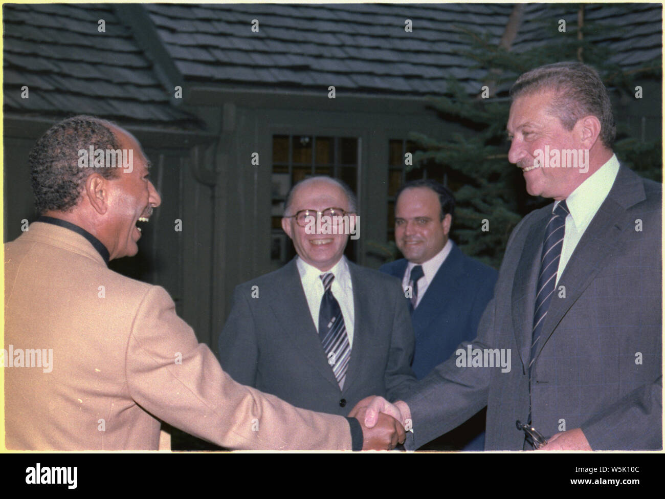 Anwar Sadat greets Ezer Weizman as Menachem Begin looks on Stock Photo