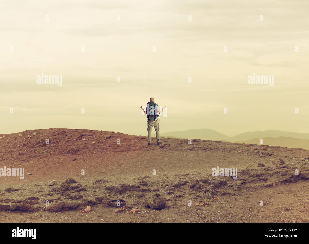 Uncertain explorer is lost in a desert. Stock Photo