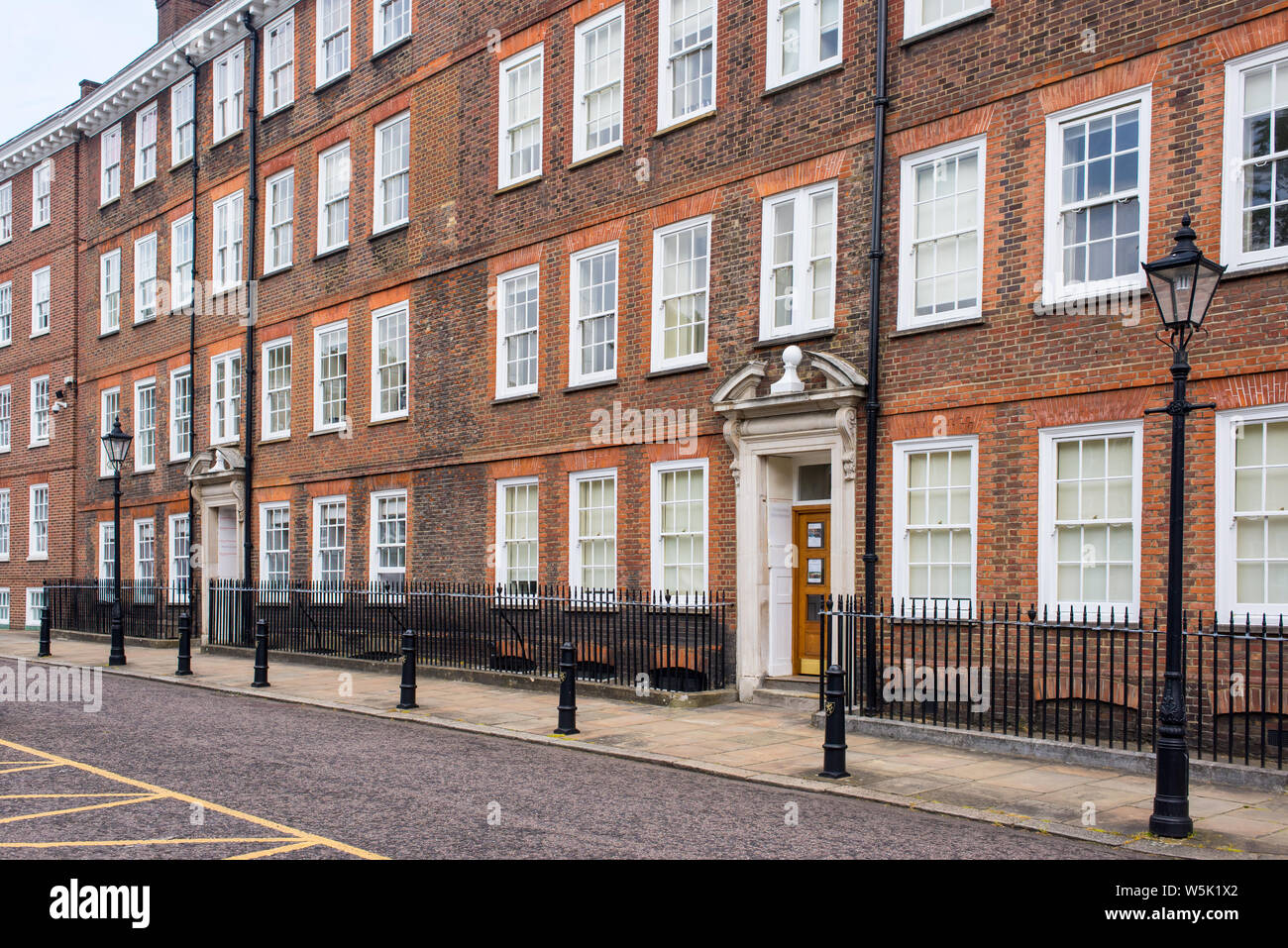Classic historical apartments Building in Georgian British English style with white windows and red brick wall in central London Stock Photo