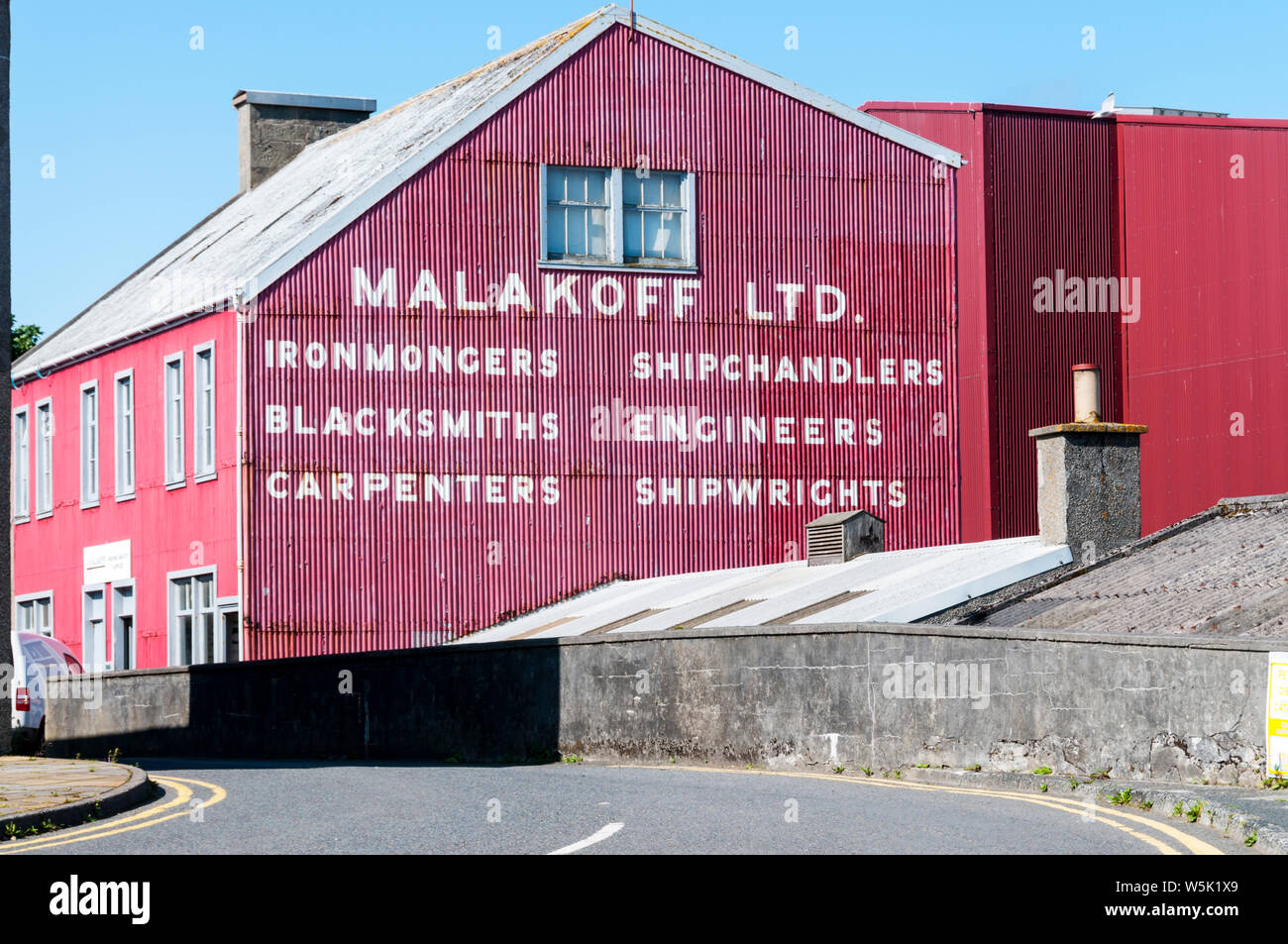 The red corrugated iron premises of Malakoff Ltd, Marine and Civil Engineers in Lerwick, Shetland. Stock Photo