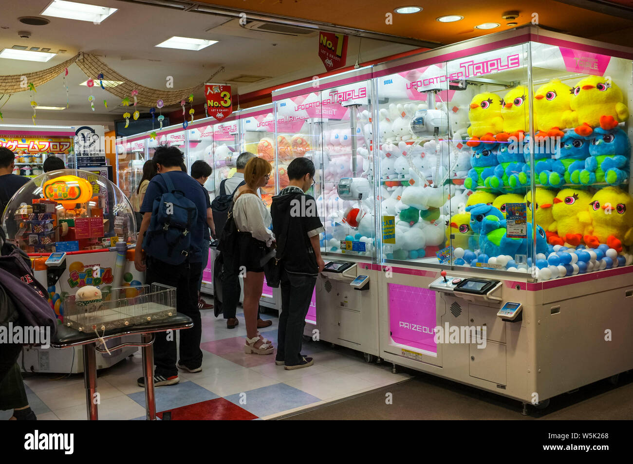 People in a game arcade in Shinjuku Tokyo. Stock Photo