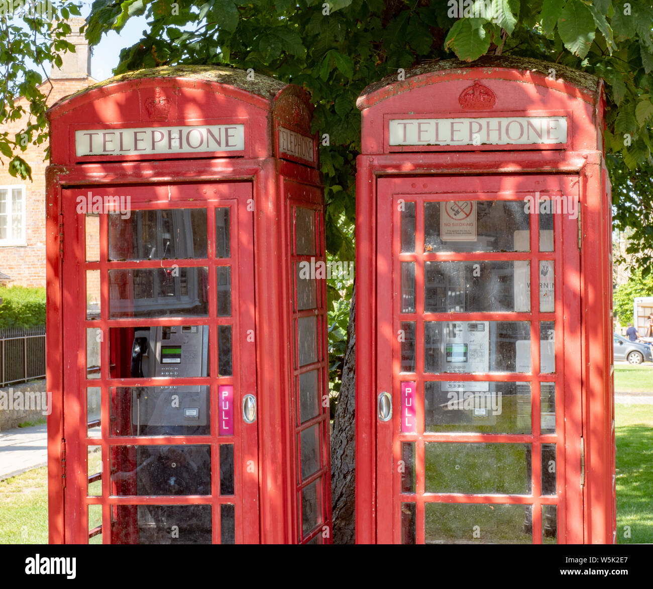 Two old style red Telephone Boxes in Broadway, Worcestershire, England, UK Stock Photo