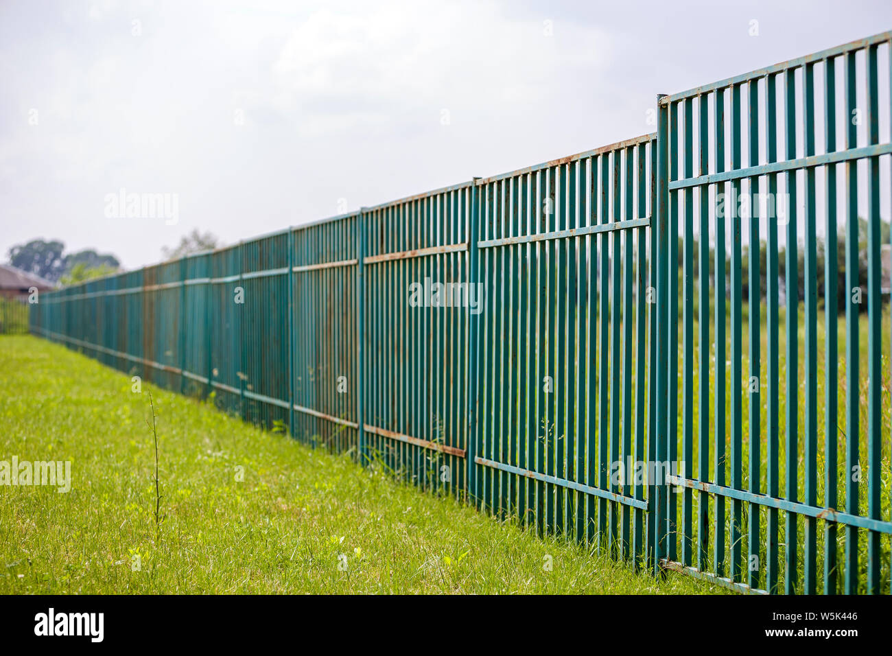 Long rusty old metalic fence Stock Photo - Alamy