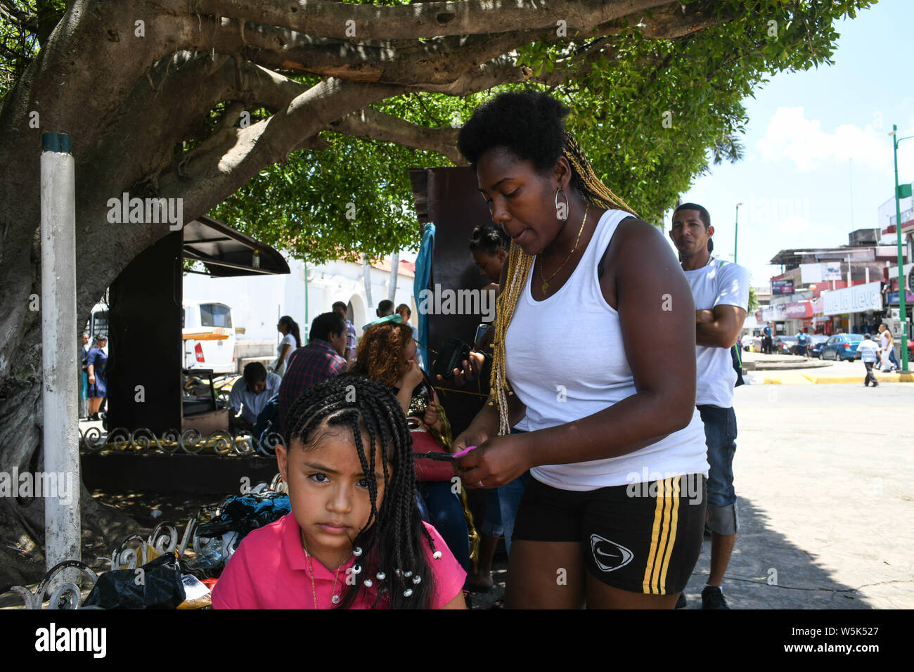 July 27, 2019, Tapachula, Chiapas, Mexico: The new global melting pot: EVELIN GONZALEZ, a Garifuna migrant from Honduras and now a Mexican resident, makes her living doing threads at main plaza, founding father Miguel Hidalgo in downtown Tapachula. Mexico has witnessed an increase of migrants crossing the country to reach the US, and now hundreds wander the streets of this southern Mexican city, which is becoming one more new global melting pot. Credit: Miguel Juarez Lugo/ZUMA Wire/Alamy Live News Stock Photo