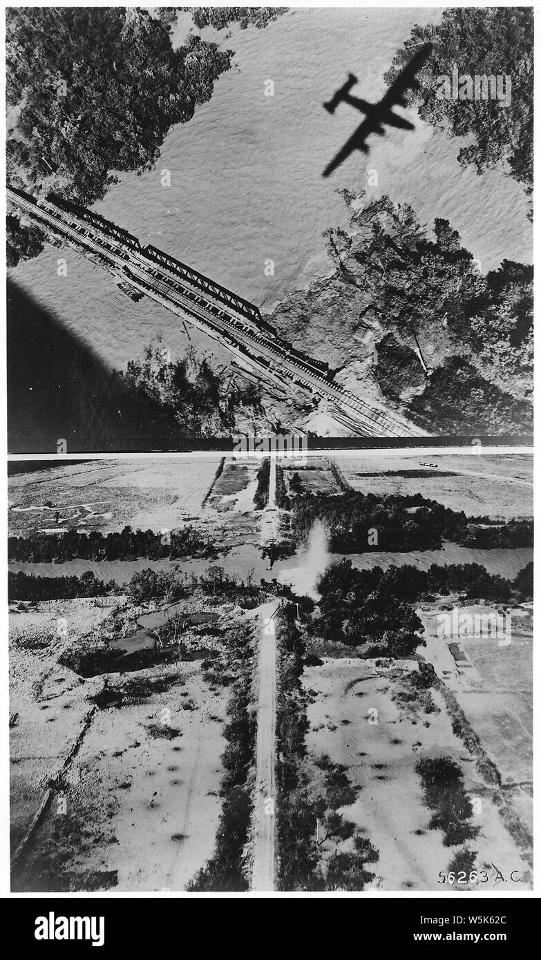 Bombing campaign. Southeast Asia & the Pacific; Scope and content:  On 27, Jan. 1945, B-24 Liberators of the 7th Bomb Group, operating under Maj. Gen. George E. Stratemeyer's Allied Eastern Air Command, knocked out three bridges on the important Moulmein-Ye rail line over which the Japanese attempt to carry a large proportion of supplies for the troops on Burma fronts. Here is one of the bridges, 35 mile south of Moulmeni, before the attack. As the B-24s leave the target. the bridge is completely destroyed and the track on both approaches lies twisted and broken. Stock Photo