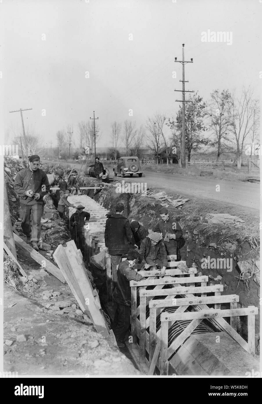 CCC Camp BR-58 Yakima-Sunnyside Project: Photo of Prosser Siphon replacement. Placing forms for the 33 inch monolithic reinforced concrete pipe. B. G. James photographer. Stock Photo