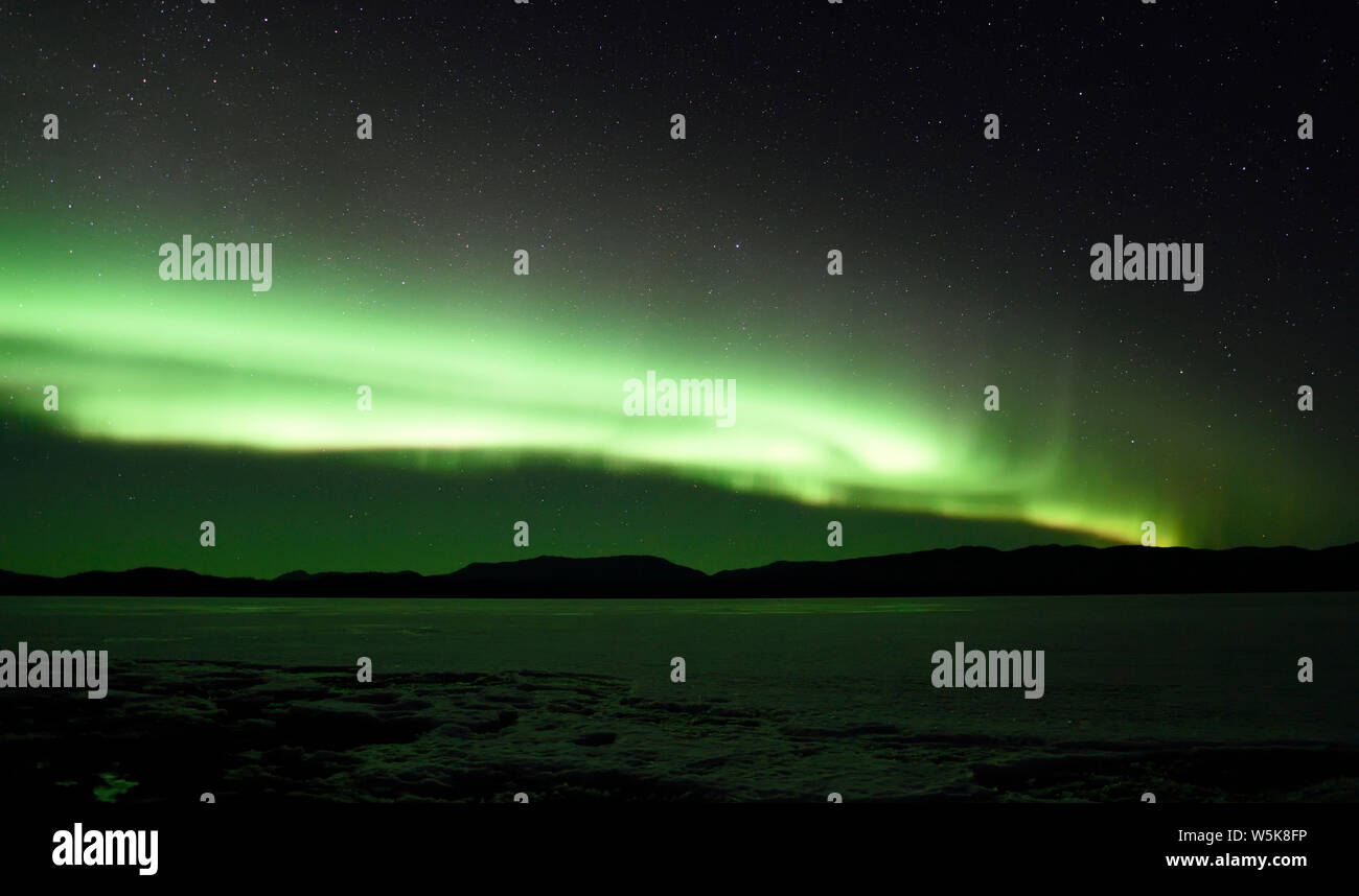 Aurora Borealis or Northern Lights from the shores of Lake Laberge north of Whitehorse, Yukon, Canada Stock Photo