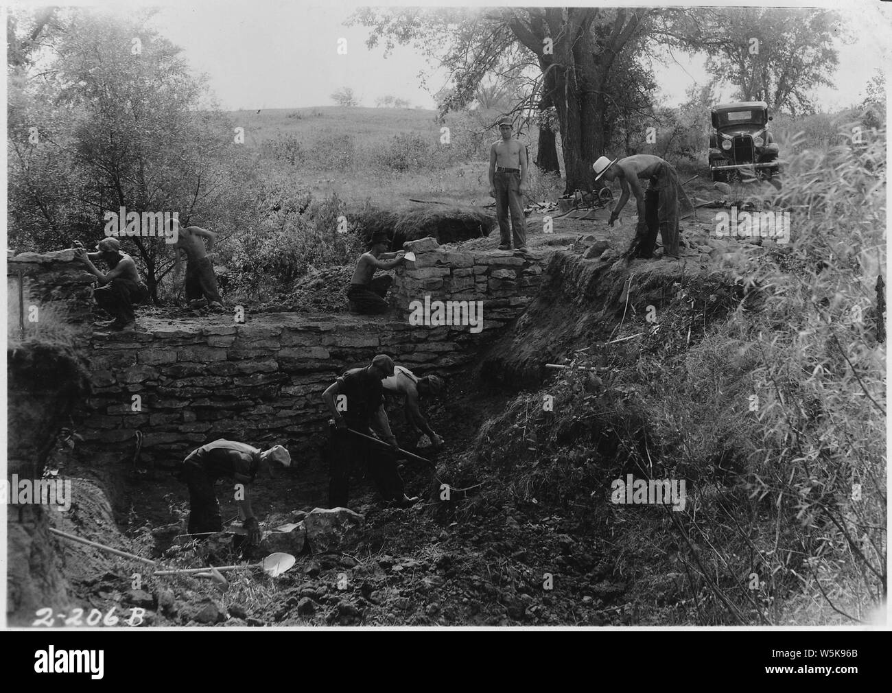 CCC boys constructing ruble masonry rock dam Stock Photo - Alamy