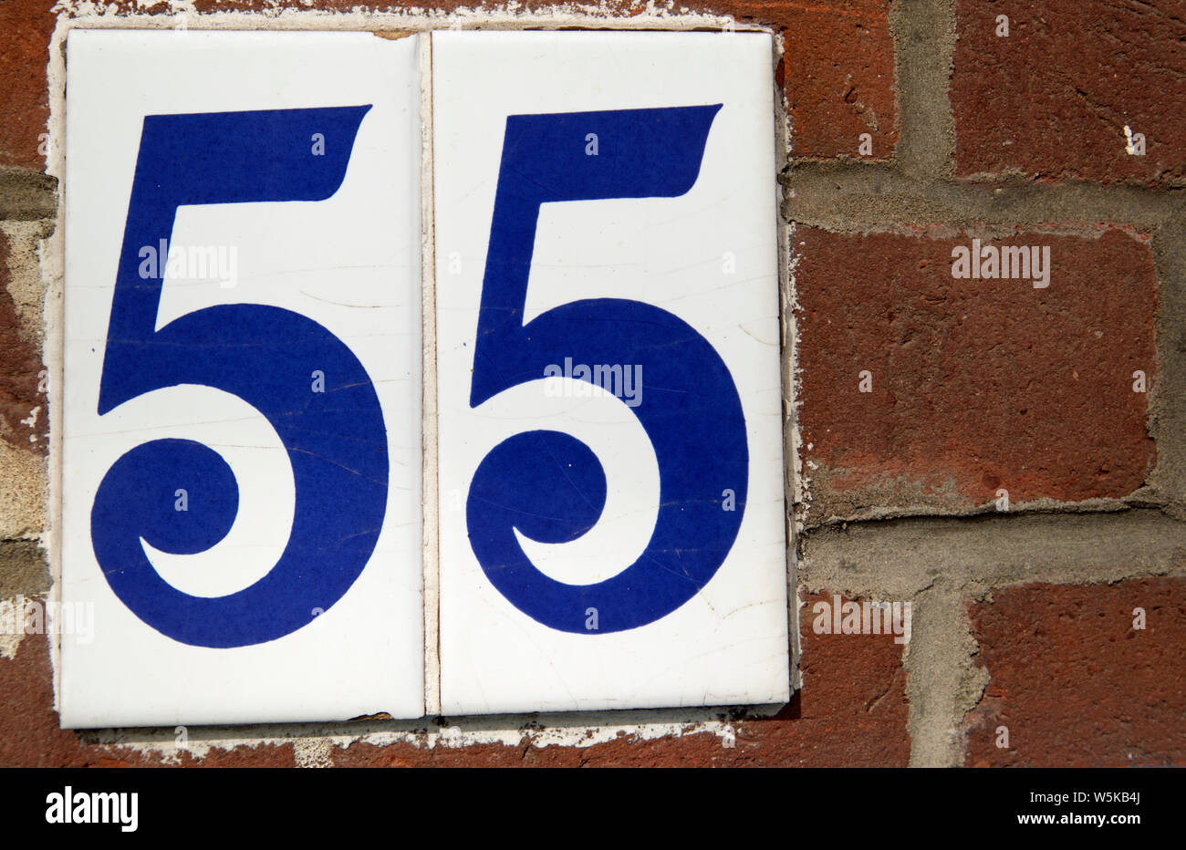Numbers on ceramic plaques read Fifty five [55] Stock Photo
