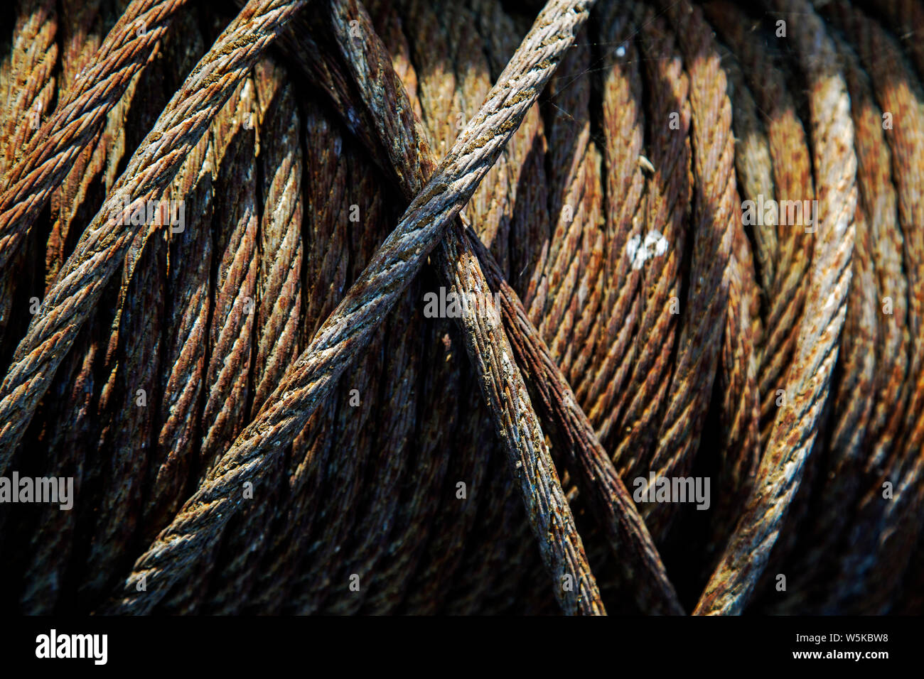 Rusted iron cables on a cylinder near the beach Stock Photo