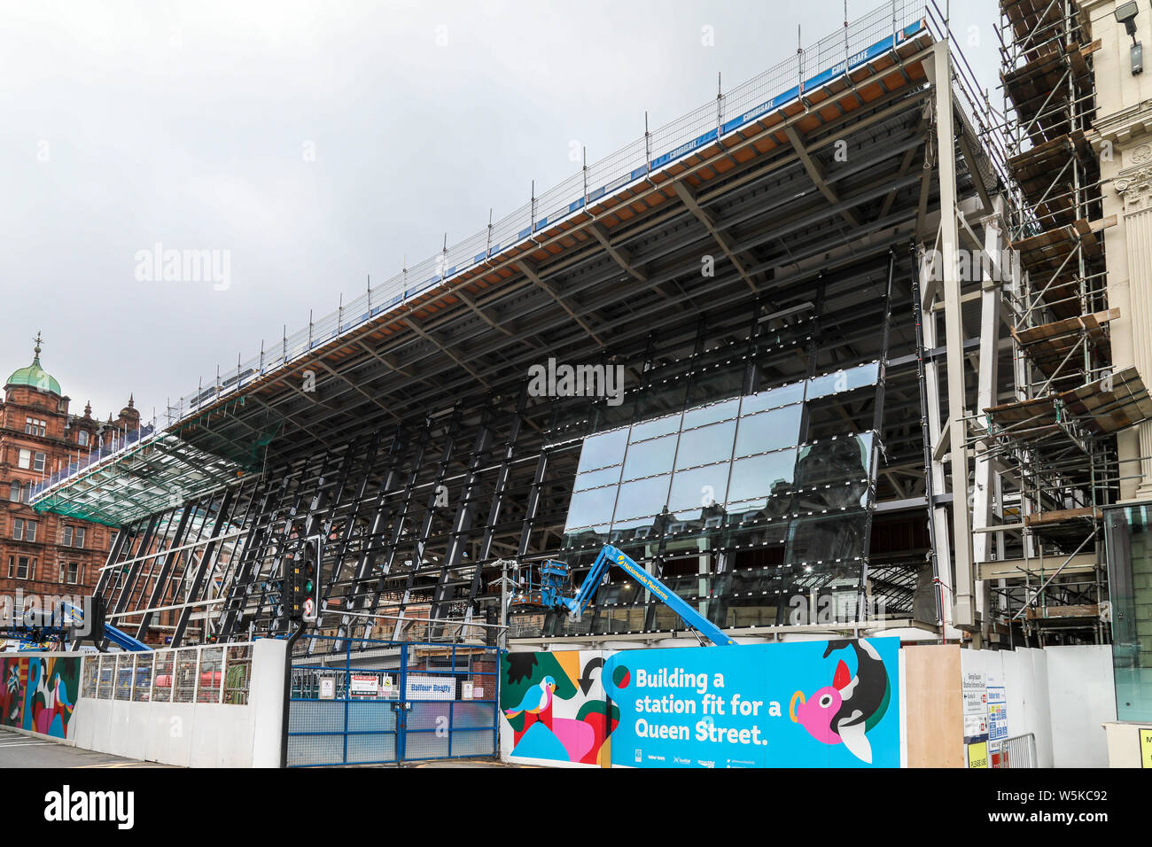 The construction of the new Glasgow Queen Street station continues as glass panels are fitted to the exterior of the building frontage Stock Photo