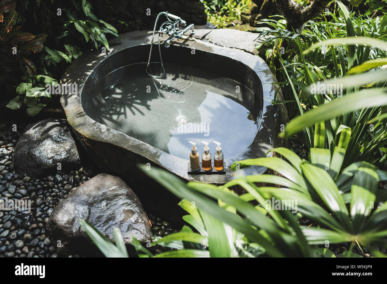 Luxury stone outdoor bath in tropical green jungle. Bali, Ubud. Concept