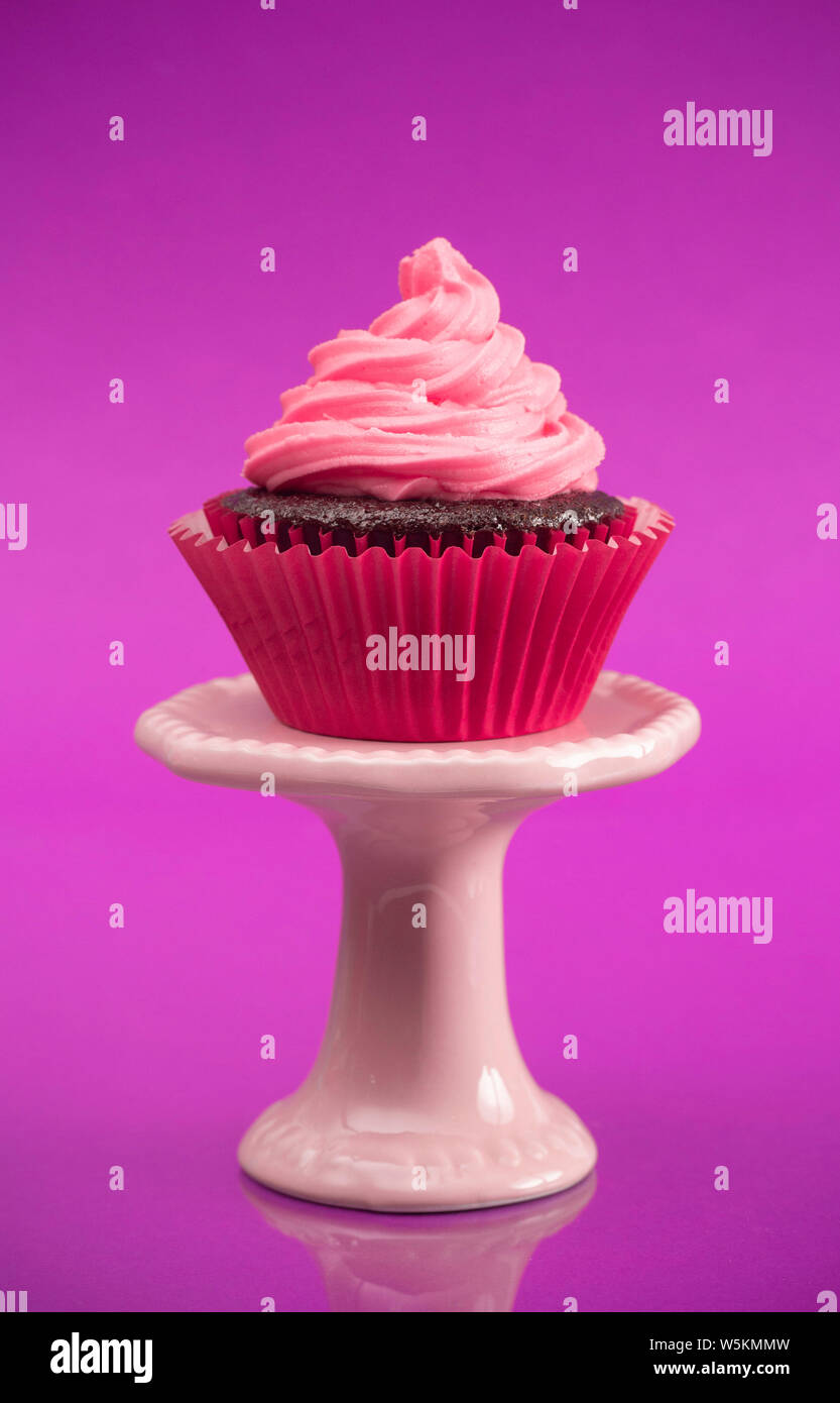 A Single Pink Cupcake on a Stand Stock Photo