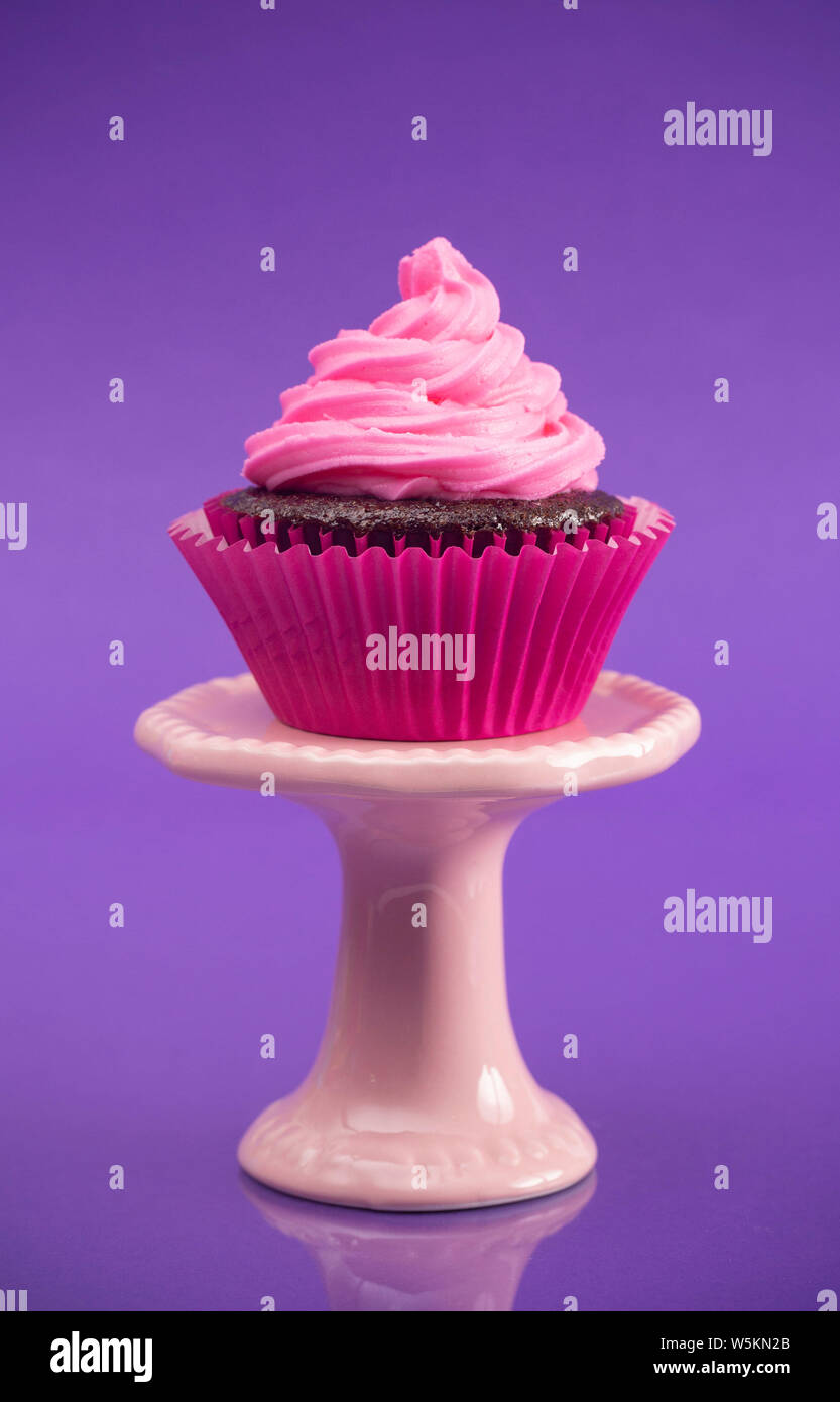 A Single Pink Cupcake on a Stand Stock Photo