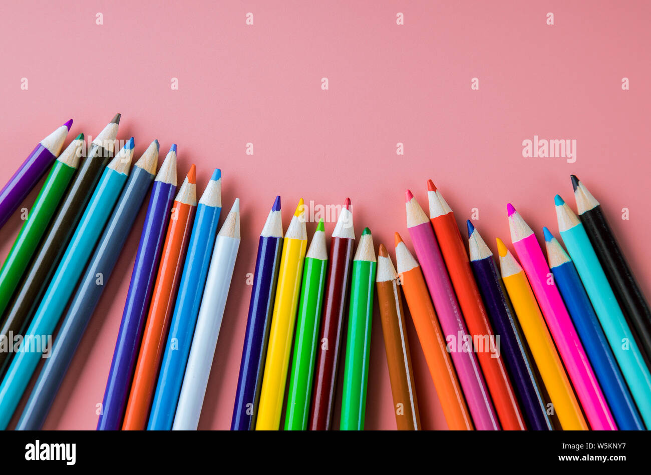 Color pencils isolated on pink background, back to school Stock Photo