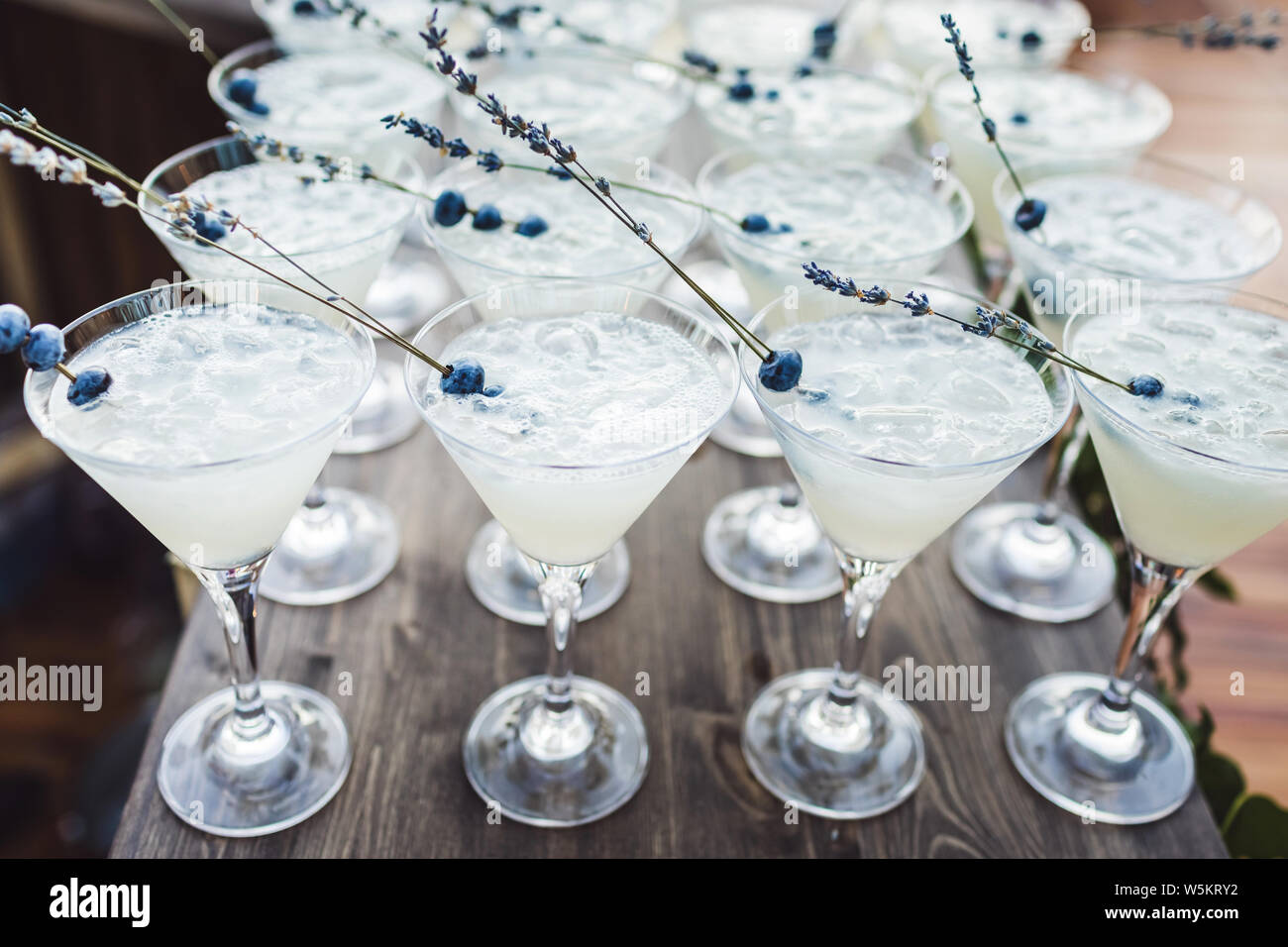 Set Of Cocktails With Ice And Blueberry On Top On Bar Counter