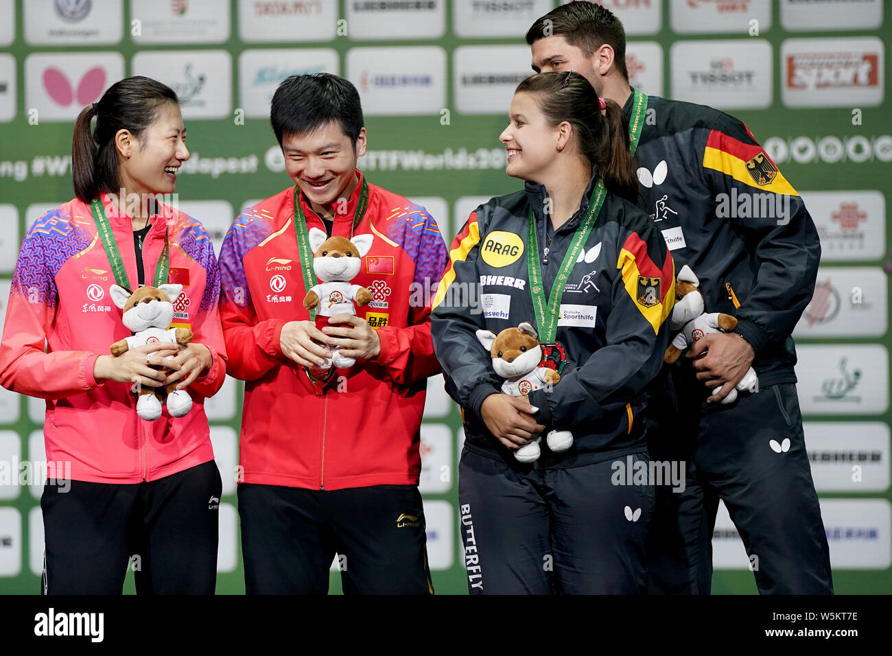 Ding Ning and Fan Zhendong of China, left, and Patrick Franziska and Petrissa Solja of Germany pose with their trophies after winning the thrid place Stock Photo