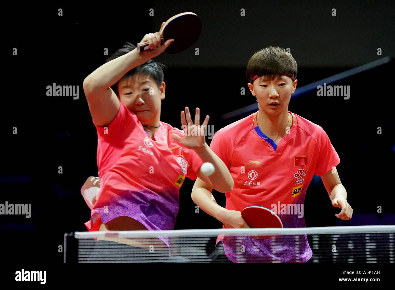 Sun Yingsha and Wang Manyu of China return a shot to Kim Jin Hyang and ...