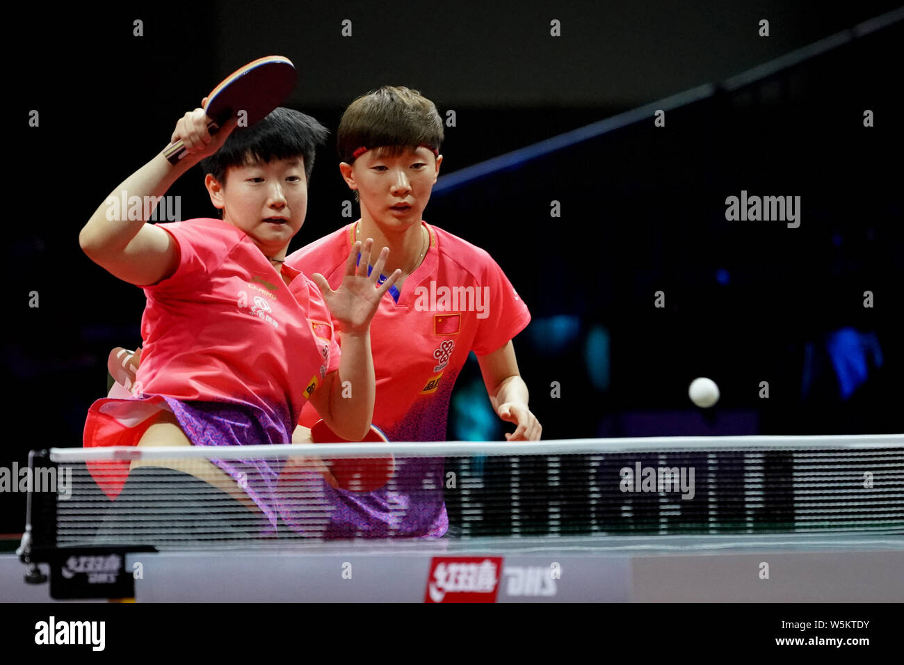 Sun Yingsha and Wang Manyu of China return a shot to Kim Jin Hyang and ...