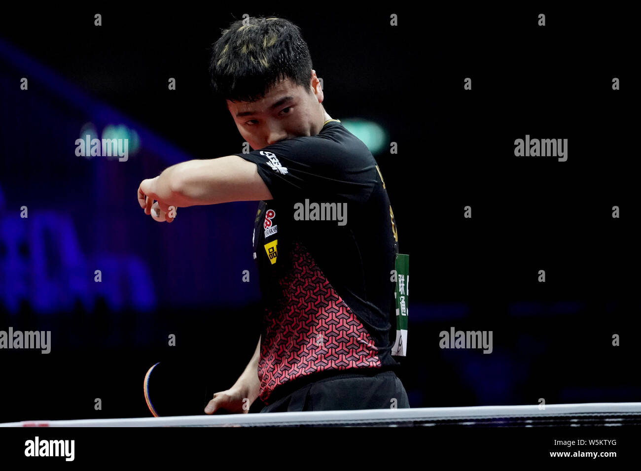 Liang Jingkun of China reacts as he competes against Panagiotis Gionis of Greece in their third round match of Men's Singles during the Liebherr 2019 Stock Photo