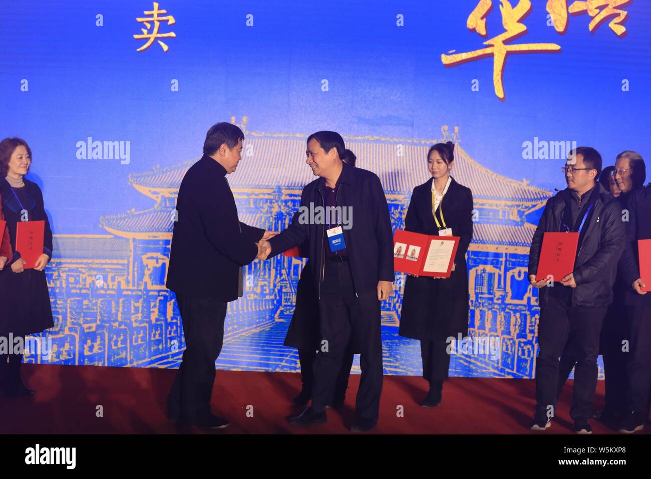 Shan Jixiang, left, the museum curator, issues the certificate for a bidder who auctioned a pair of historically accurate Heavenly Lanterns (tian deng Stock Photo
