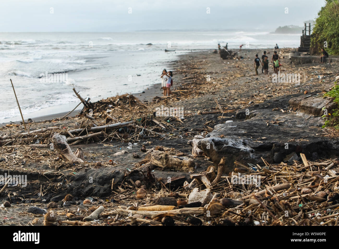 BALI, INDONESIA - APRIL 31, 2019: Beach pollution in Bali. Hard life of local people around garbage on the beach. Recycling waste problem Stock Photo