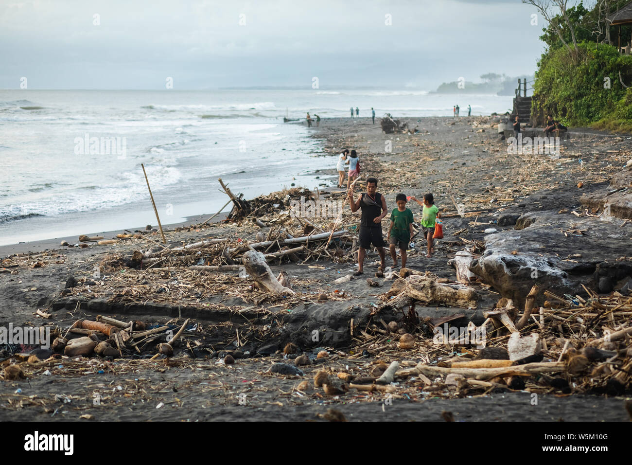 BALI, INDONESIA - APRIL 31, 2019: Beach pollution in Bali. Hard life of local people around garbage on the beach. Recycling waste problem Stock Photo