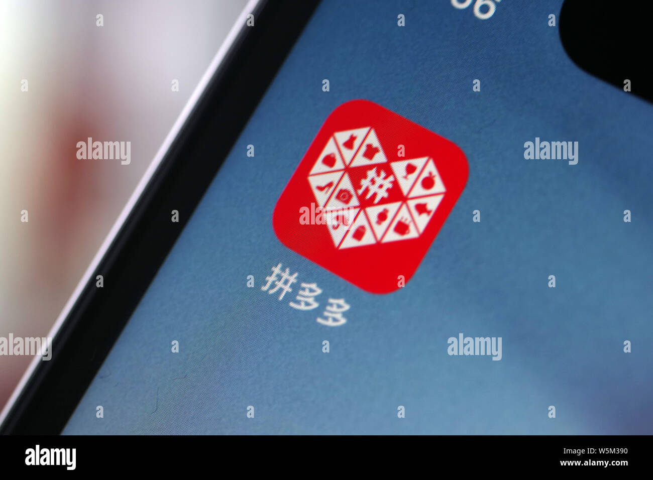 A netizen shows the icon of Chinese social e-commerce giant Pinduoduo ...