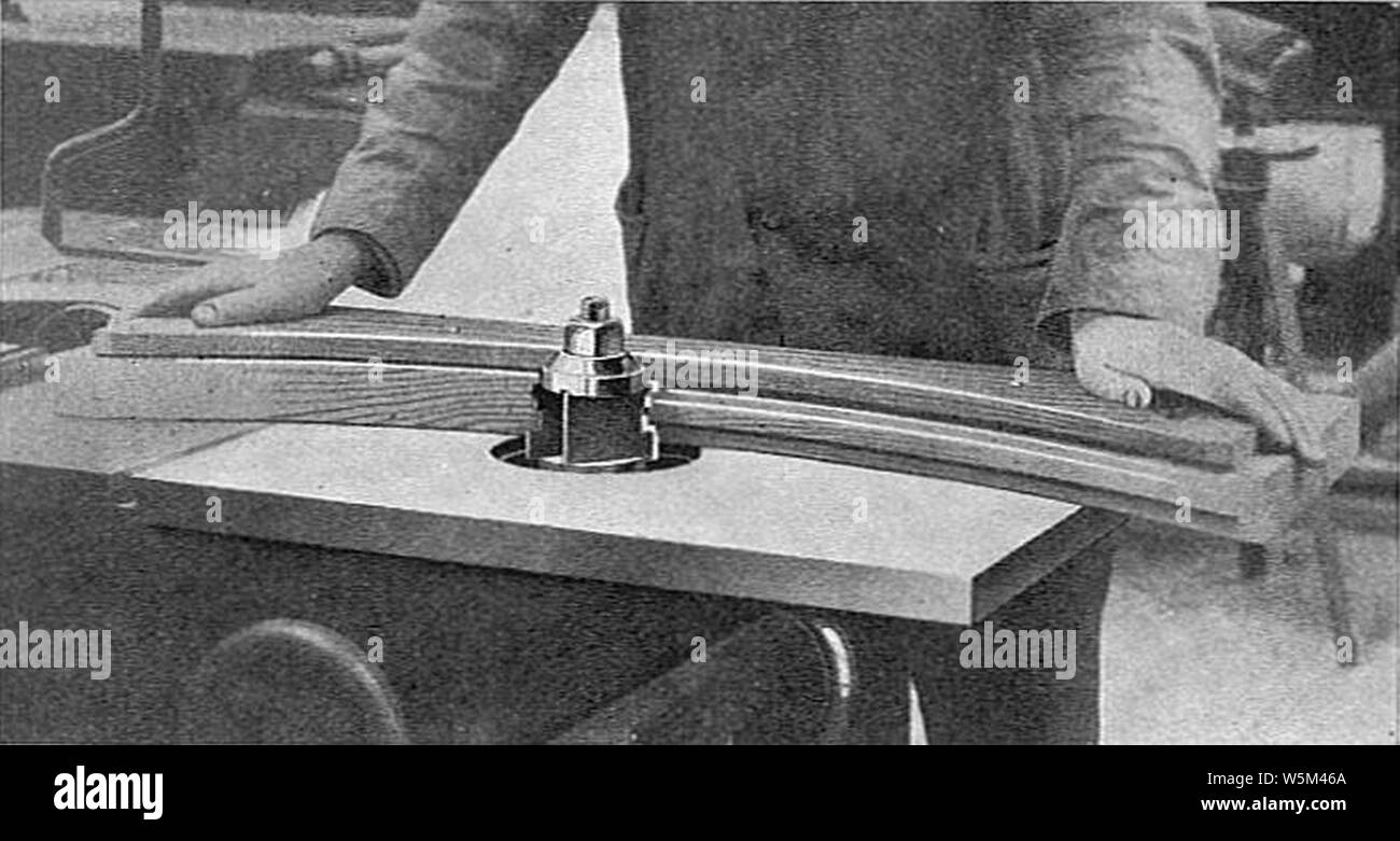 Curved work on a spindle moulder (Carpentry and Joinery 1925). Stock Photo