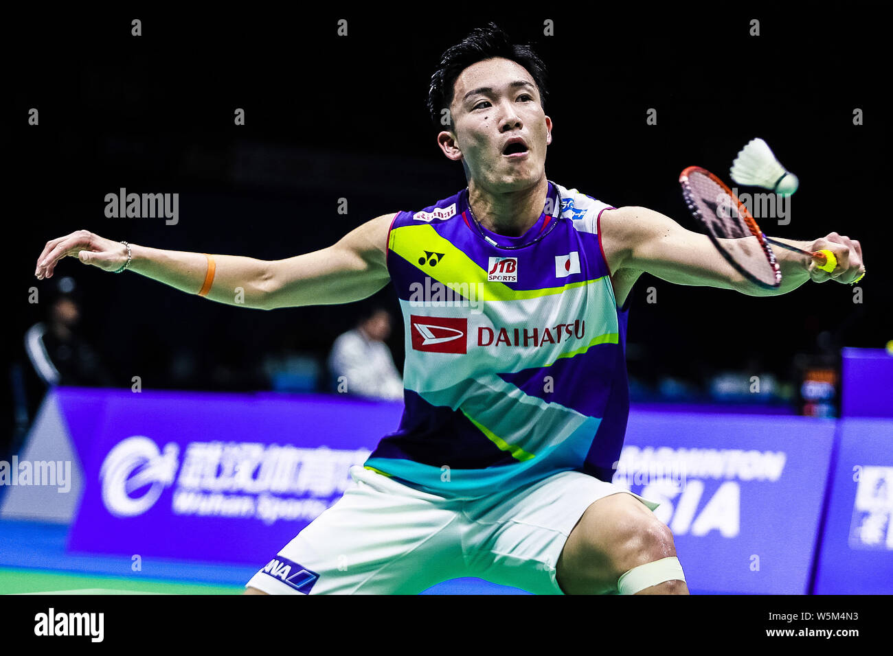 Kento Momota of Japan returns a shot to Lee Dong-keun of South Korea in ...