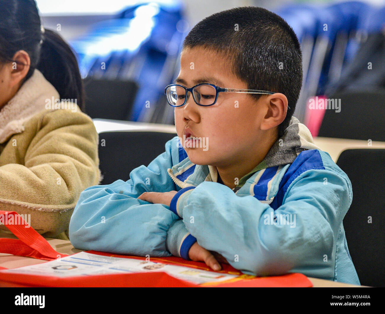 --FILE--A near-sighted young Chinese boy student attends a lecture about prevention of myopia at an eye hospital in Xi'an city, northwest China's Shaa Stock Photo